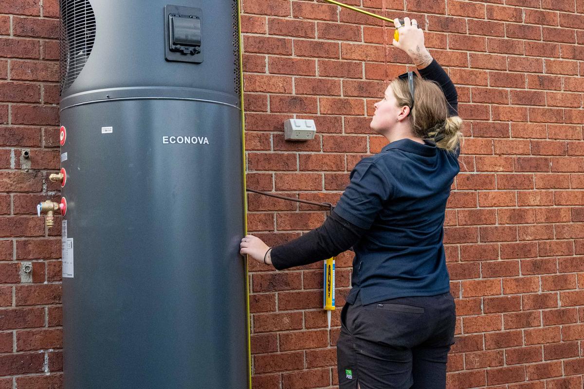 Goldsure installer fitting a heat pump hot water system at a Melbourne property