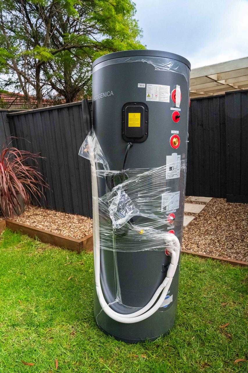 Goldsure heat pump hot water system in a backyard