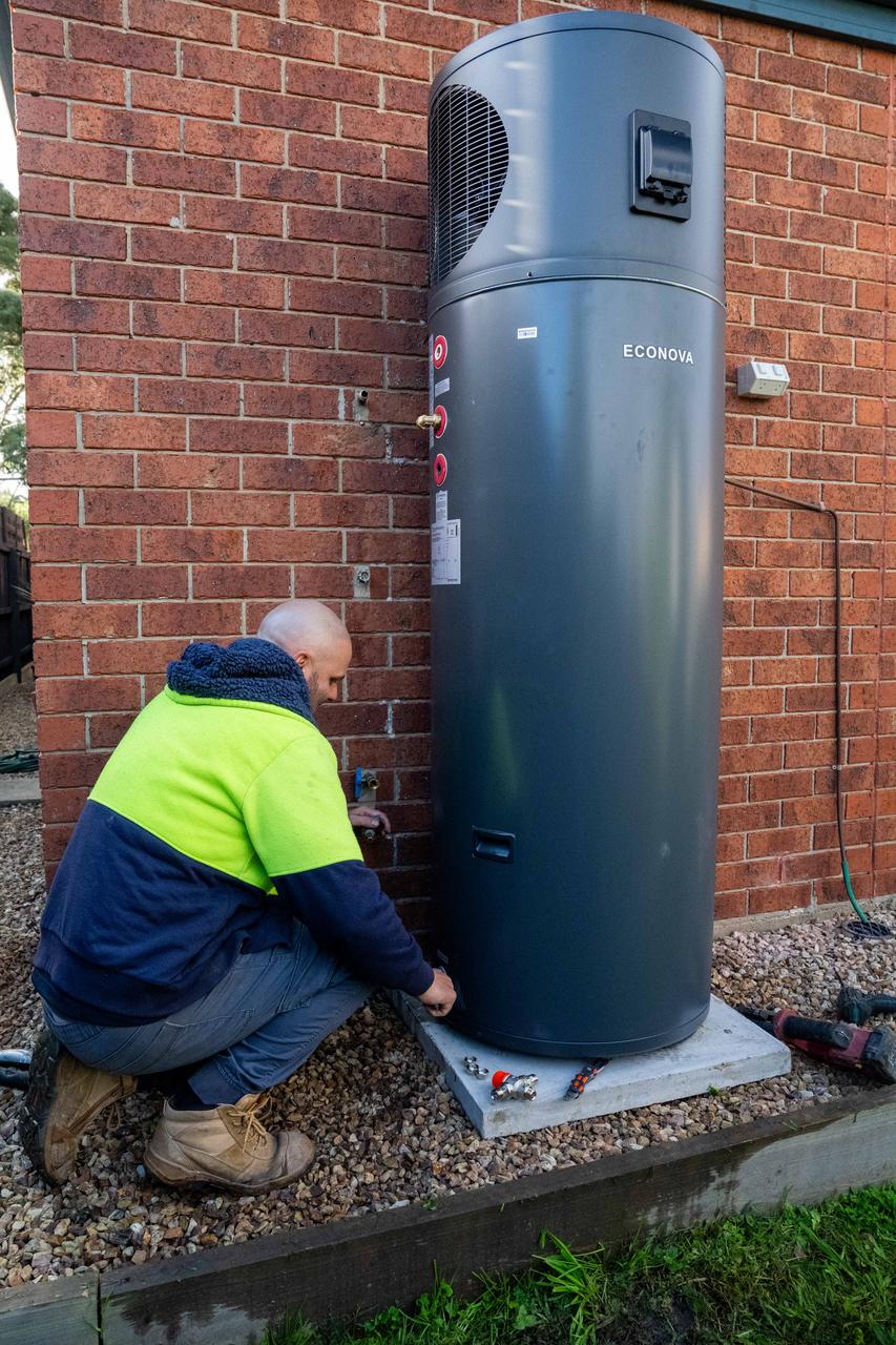 Goldsure installer fitting a heat pump hot water system