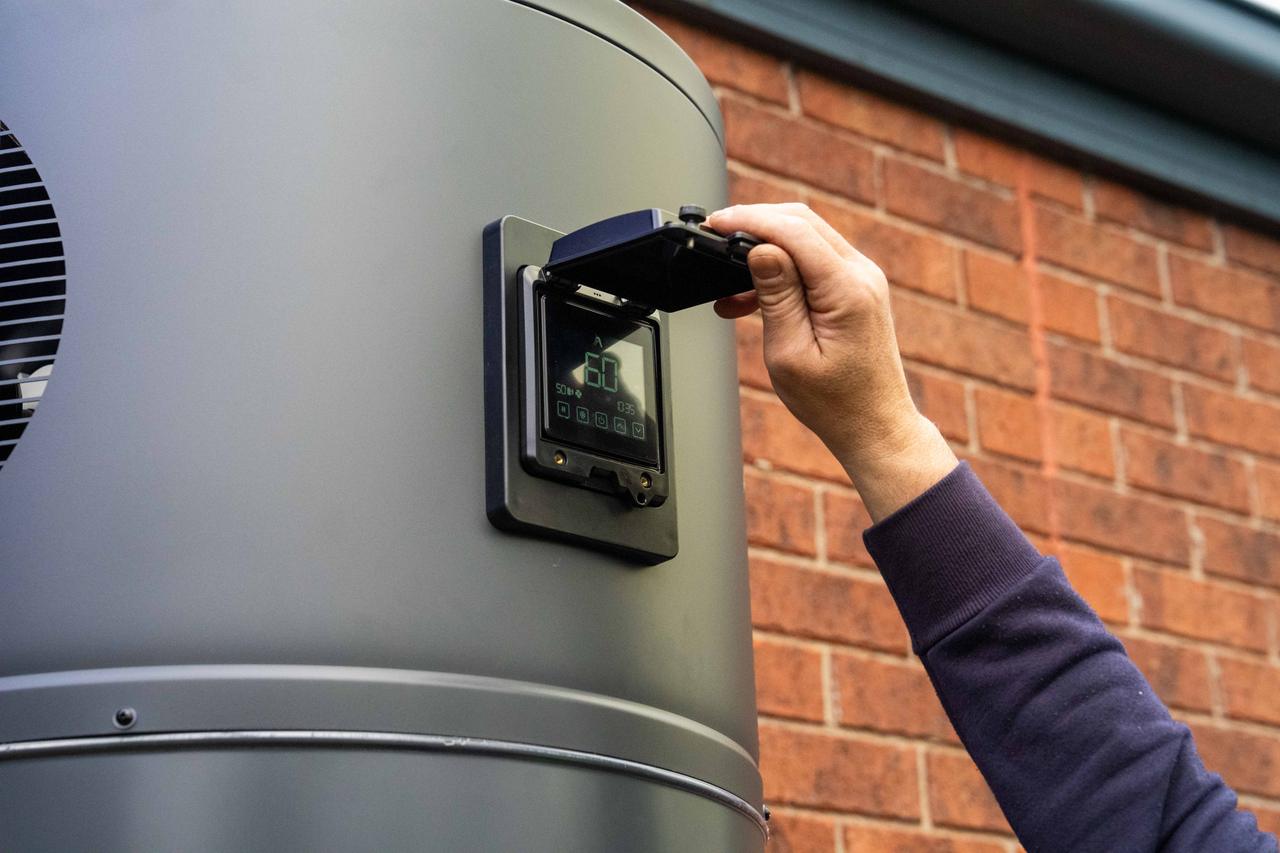 Goldsure installer wiring a heat pump control